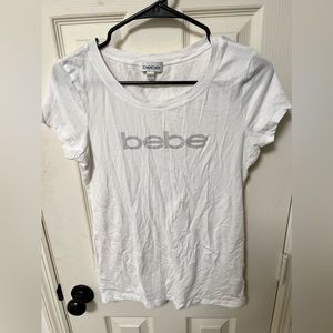SOLD bebe white short sleeve shirt, with “bebe” writing in silver gems, large